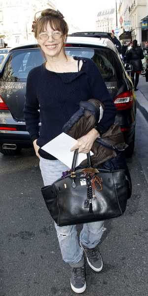 Jane Birkin carrying a Hermes Birkin handbag