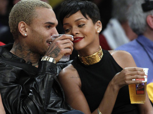 Entertainers Chris Brown, left, and Rihanna attend an NBA basketball game between the Los Angeles Lakers and New York Knicks in Los Angeles, Tuesday, Dec. 25, 2012. The Lakers won 100-94. (AP Photo/Alex Gallardo) 