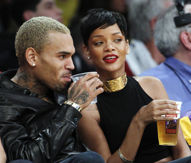 Entertainers Chris Brown, left, and Rihanna attend an NBA basketball game between the Los Angeles Lakers and New York Knicks in Los Angeles, Tuesday, Dec. 25, 2012. The Lakers won 100-94. (AP Photo/Alex Gallardo)